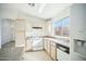 Cozy kitchen features white appliances, ample cabinetry, and a window for natural lighting at 7557 W Colter St, Glendale, AZ 85303