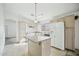 Spacious kitchen featuring a large island, white appliances, and ample cabinet space at 7557 W Colter St, Glendale, AZ 85303