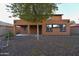 Backyard featuring small rock ground covering and a covered patio on this two-story home at 8776 W Peppertree Ln, Glendale, AZ 85305