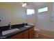 Bathroom features a double sink vanity, granite countertop, and soaking tub at 8776 W Peppertree Ln, Glendale, AZ 85305