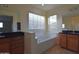 Bright bathroom featuring dual vanities, a soaking tub, and tiled floors at 8776 W Peppertree Ln, Glendale, AZ 85305