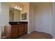 Bathroom featuring a vanity with a dark countertop and a mirror with decorative lighting at 8776 W Peppertree Ln, Glendale, AZ 85305