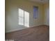 Light-filled bedroom with plush carpet and a large window at 8776 W Peppertree Ln, Glendale, AZ 85305