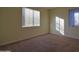 Bright bedroom featuring plush carpet and two windows for ample light at 8776 W Peppertree Ln, Glendale, AZ 85305