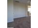 An empty bedroom showcases the neutral color palette and plush carpeting at 8776 W Peppertree Ln, Glendale, AZ 85305