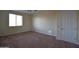 This bedroom features neutral walls, ceiling fan, carpeted flooring, and a window at 8776 W Peppertree Ln, Glendale, AZ 85305