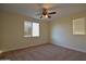 Well-lit bedroom with plush carpet and bright window with blind at 8776 W Peppertree Ln, Glendale, AZ 85305