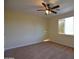 Spacious bedroom features plush carpet, ceiling fan, and a bright window at 8776 W Peppertree Ln, Glendale, AZ 85305