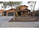 Charming two-story home with a three car garage and desert landscaping at 8776 W Peppertree Ln, Glendale, AZ 85305