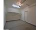 A spacious garage with epoxy floor, overhead storage rack, and plenty of room at 8776 W Peppertree Ln, Glendale, AZ 85305