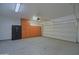 Garage with painted floors, built-in storage, and a large safe on the back wall at 8776 W Peppertree Ln, Glendale, AZ 85305