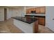 Bright kitchen featuring a center island, stainless appliances, and tile flooring at 8776 W Peppertree Ln, Glendale, AZ 85305