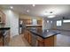 Bright kitchen featuring a center island, stainless appliances, and tile flooring at 8776 W Peppertree Ln, Glendale, AZ 85305