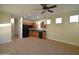 Well-lit kitchen featuring tile floors, wood cabinets, modern appliances, and ample counter space at 8776 W Peppertree Ln, Glendale, AZ 85305