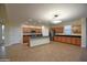 Large open kitchen with a center island, modern lighting, stainless steel appliances, and tile floors at 8776 W Peppertree Ln, Glendale, AZ 85305