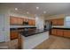 Bright kitchen featuring a center island, stainless appliances, and tile flooring at 8776 W Peppertree Ln, Glendale, AZ 85305