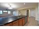 Stylish kitchen island boasts dark countertops, stainless steel appliances, and custom wood cabinetry at 8776 W Peppertree Ln, Glendale, AZ 85305