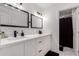 Contemporary bathroom boasting double sinks, sleek fixtures, and a view into a tiled shower area at 9050 S Calle Tomi --, Guadalupe, AZ 85283