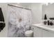 Bathroom featuring a marble-look shower curtain and a modern, white vanity at 9050 S Calle Tomi --, Guadalupe, AZ 85283