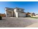 Two-story home featuring stucco siding, a two-car garage, and minimal desert landscaping in the front yard at 9050 S Calle Tomi --, Guadalupe, AZ 85283