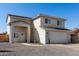 Two-story home featuring stucco siding, a two-car garage, and minimal desert landscaping in the front yard at 9050 S Calle Tomi --, Guadalupe, AZ 85283