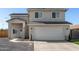 Two-story home featuring stucco siding, a two-car garage, and minimal desert landscaping in the front yard at 9050 S Calle Tomi --, Guadalupe, AZ 85283