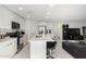 Well-lit kitchen featuring white cabinets, stainless steel appliances, and a breakfast island at 9050 S Calle Tomi --, Guadalupe, AZ 85283