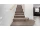 Carpeted staircase with a wooden handrail leading to the upper level of the home at 9050 S Calle Tomi --, Guadalupe, AZ 85283