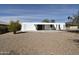 Home exterior featuring a white wood facade with desert landscaping and a covered patio area at 9431 W Timberline Dr, Sun City, AZ 85351