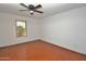 Bedroom with laminate floors, ceiling fan, and good natural light from the backyard view at 9431 W Timberline Dr, Sun City, AZ 85351