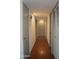 Hallway featuring laminate floors and several doors including a closet and bedrooms at 9431 W Timberline Dr, Sun City, AZ 85351