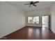 Bright living room featuring sleek laminate flooring, ceiling fan, and entry to the home at 9431 W Timberline Dr, Sun City, AZ 85351