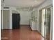 Open living area with white walls, recessed lighting, and door to the patio at 9431 W Timberline Dr, Sun City, AZ 85351