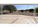 Covered patio view showcases the home's backyard with mature trees and desert landscaping at 9431 W Timberline Dr, Sun City, AZ 85351