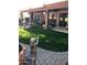 Backyard featuring fountain, manicured grass, a covered patio and seating at , Gilbert, AZ 85234