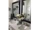 Bathroom featuring dual sinks, quartz countertops, and dark framed mirrors at , Gilbert, AZ 85234