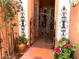 Lovely gated entrance adorned with wrought iron, flowers, and mature landscaping at , Gilbert, AZ 85234