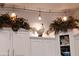 White cabinets with a decorative rooster and greenery on top at , Gilbert, AZ 85234