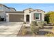 Charming single-story home with a two-car garage, neutral colors, and desert landscaping at 10064 E Tamery Ave, Mesa, AZ 85212