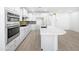 Modern kitchen featuring white cabinets, a large island, and stainless steel appliances at 10064 E Tamery Ave, Mesa, AZ 85212