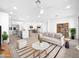 Bright, open living room with white tile floors and modern furnishings flowing into the kitchen at 10064 E Tamery Ave, Mesa, AZ 85212