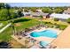 Aerial shot of the community pool area, showcasing the pool, spa, and surrounding landscape at 10119 N 96Th Ave # B, Peoria, AZ 85345