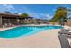 Community pool with lounge chairs and tables, perfect for relaxation and socializing at 10119 N 96Th Ave # B, Peoria, AZ 85345