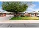 Charming single-story brick home with a well-maintained lawn and mature tree at 10119 N 96Th Ave # B, Peoria, AZ 85345