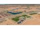 An aerial view of a new construction neighborhood, park, and lake at 10255 S Bickwell Trl, Apache Junction, AZ 85120