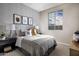 This cozy bedroom features stylish bedding, baseball decor, and soft light from a bright window at 10255 S Bickwell Trl, Apache Junction, AZ 85120