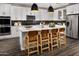 Modern kitchen with a kitchen island, white cabinets, pendant lights, and stainless steel appliances at 10255 S Bickwell Trl, Apache Junction, AZ 85120