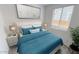 Bright bedroom with a comfortable bed, side tables, and a calming blue color scheme at 10271 S Bickwell Trl, Apache Junction, AZ 85120