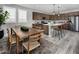 Open-concept kitchen and dining area featuring modern appliances, pendant lighting, and a wooden dining table at 10308 S Bickwell Trl, Apache Junction, AZ 85120