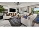 Bright, airy living room with modern furnishings, a sleek TV, and an elegant area rug at 10308 S Bickwell Trl, Apache Junction, AZ 85120